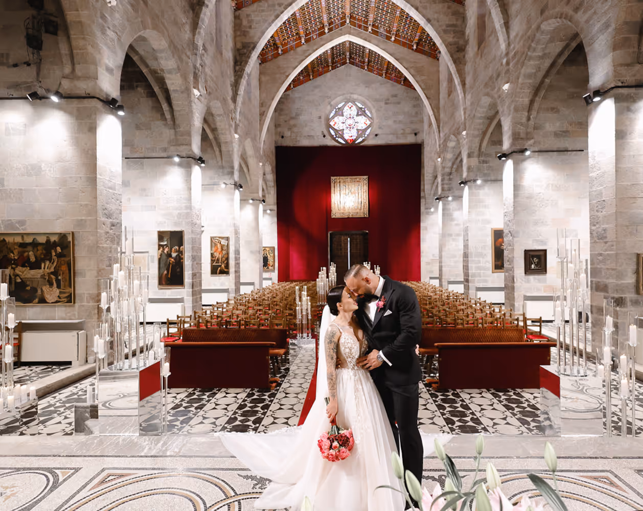 Wedding in Spain. Peralada. A young couple in church embracing each other.