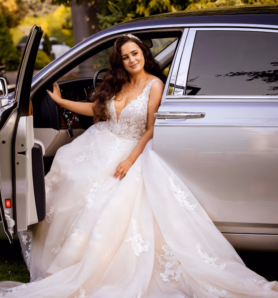 Wedding in Piekary Śląskie. Poland. A shot of the bride sitting in a car with the doors open