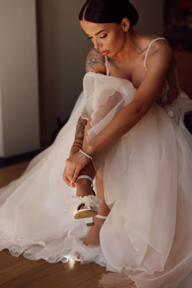 Wedding in Spain. Peralada. A shot of the bride putting on her wedding shoes