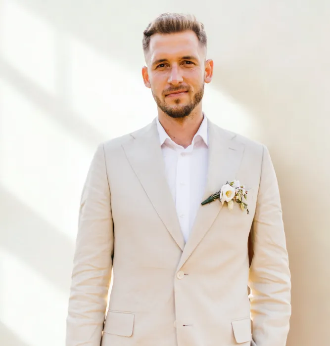 A wedding in Greece. Santorini. A shot of the groom holding a baby in his arms.