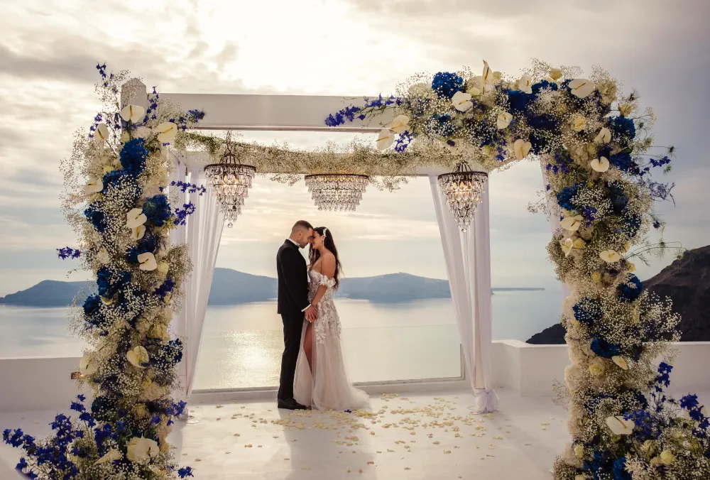 Wedding in Greece. Santorini. Young couple during the wedding ceremony on a cliff overlooking the sea.