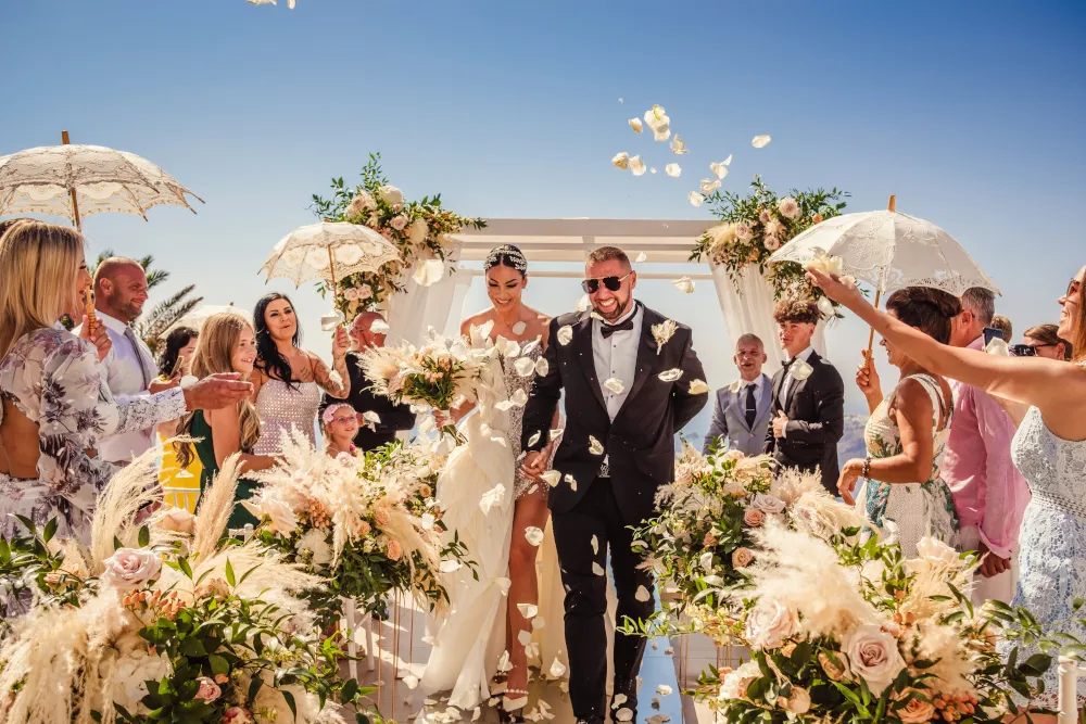 Wedding in Greece. Santorini. Photo of the bride and groom with wedding guests.