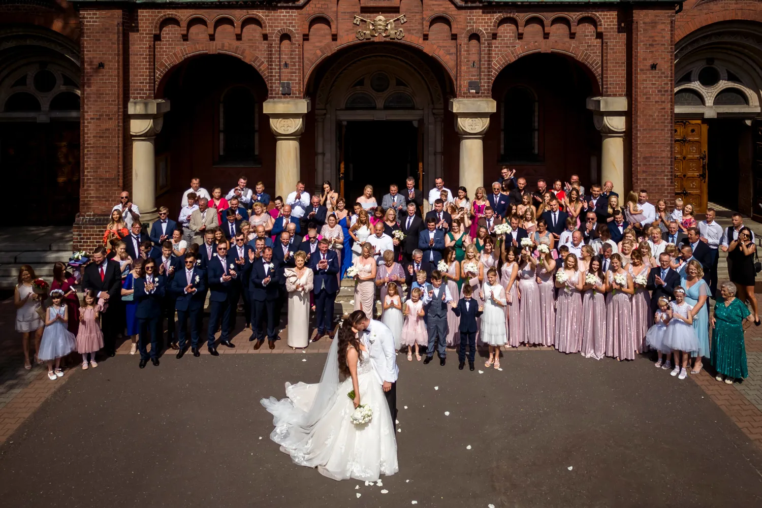 Wedding in Piekary Śląskie. Poland. Photo of the bride and groom with all guests outdoors